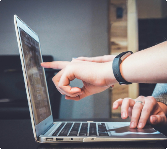 People pointing at computer, reviewing insurance options